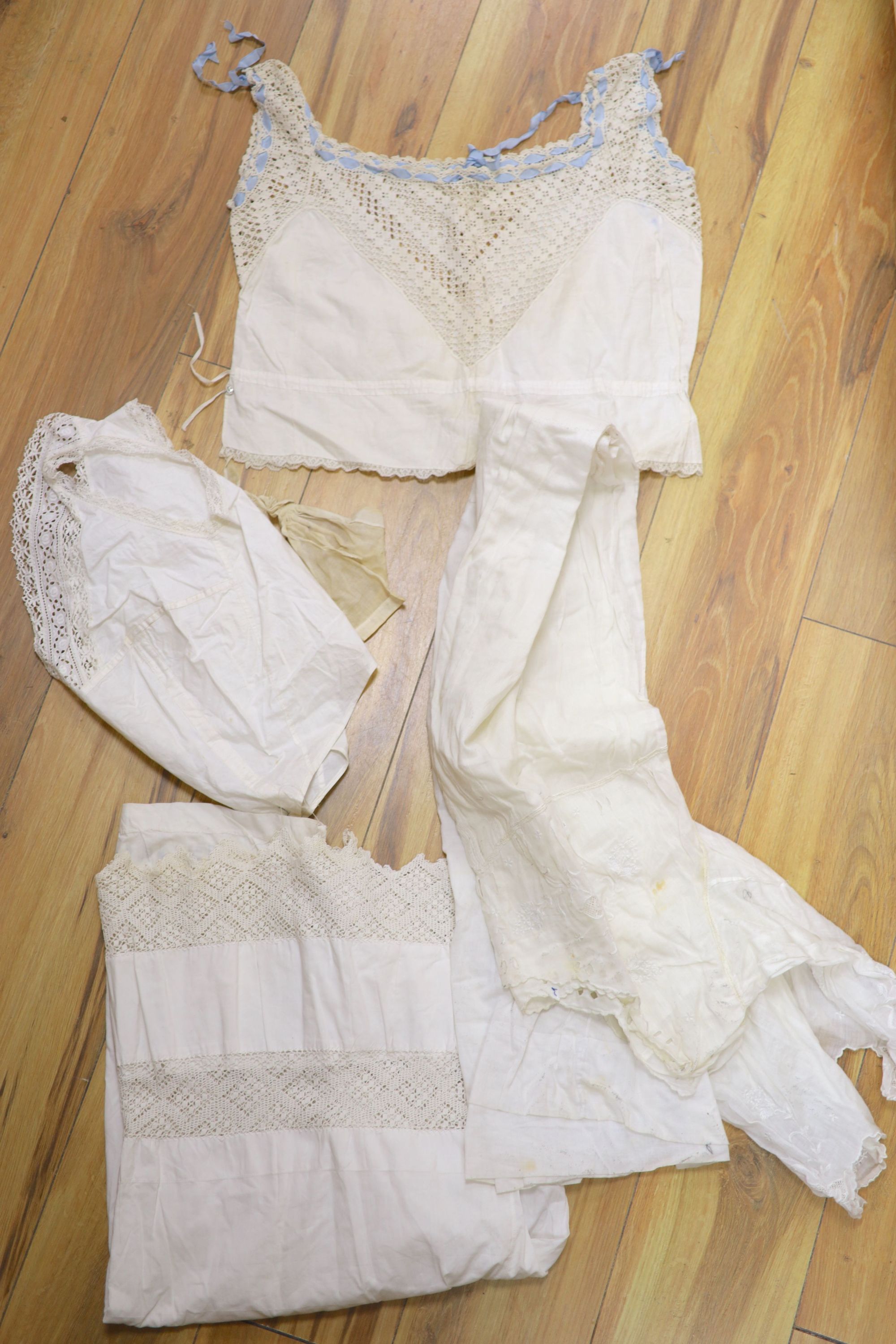 A collection of Victorian white worked camisoles, petticoats and underwear